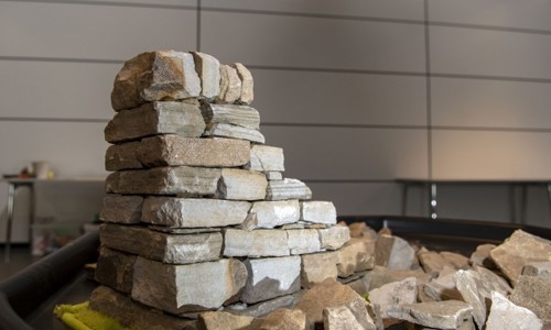 A low, stone wall build on top of a table