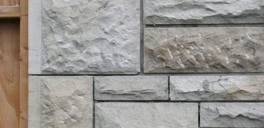 A sandstone wall made up of square blocks